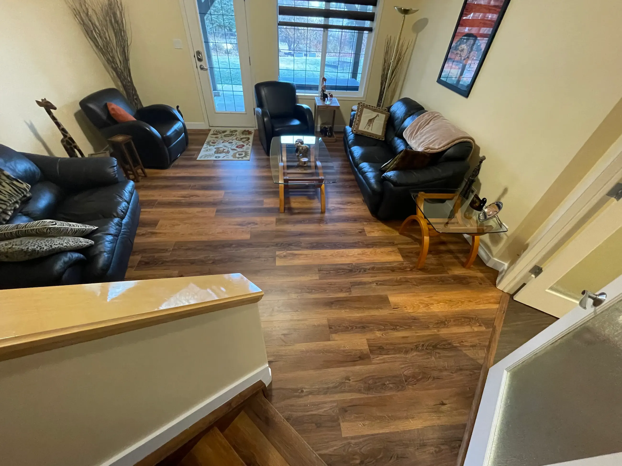 Vinyl plank flooring and white baseboards installed in a residential living room