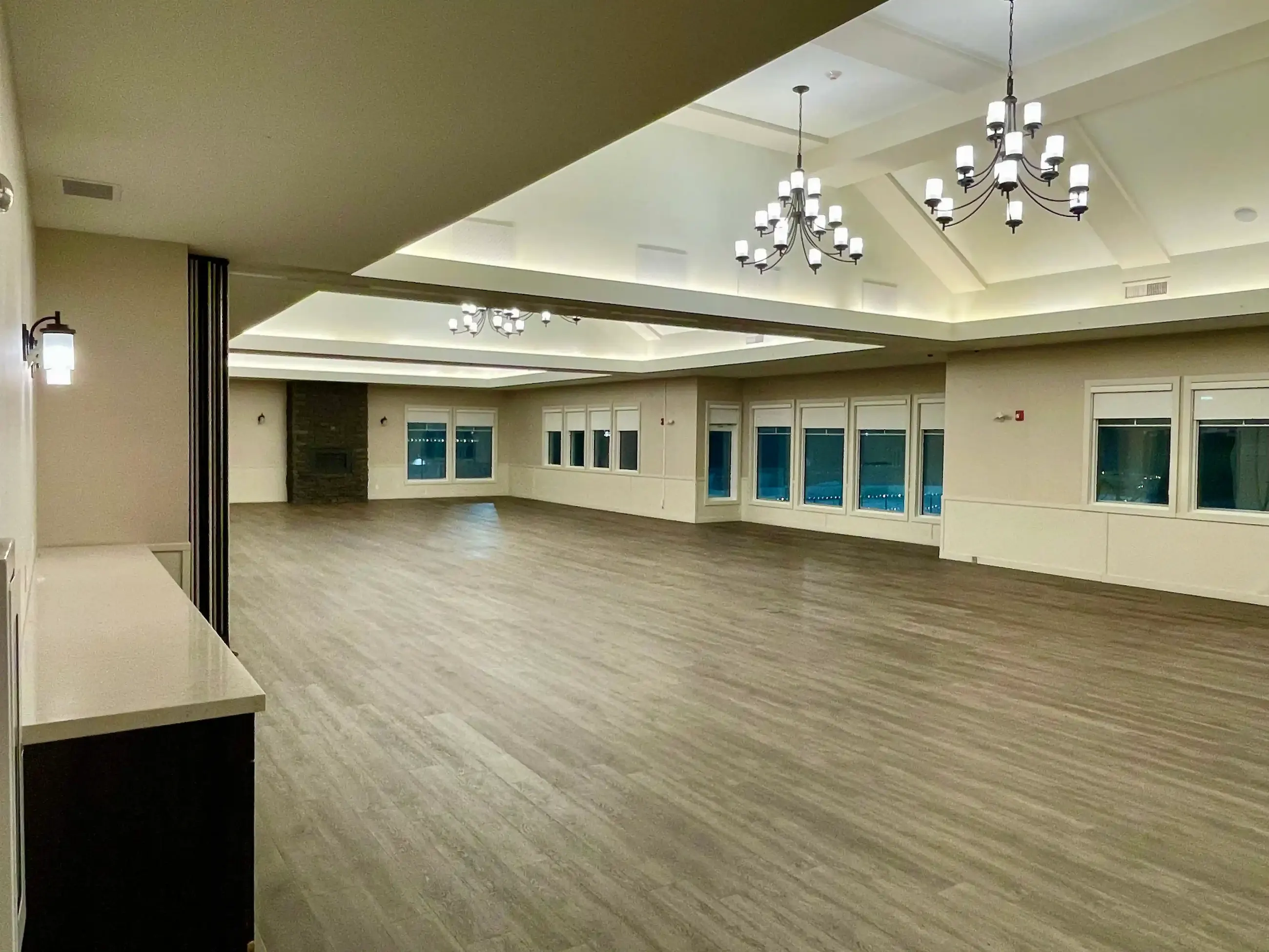 Large amenity room with grey wood-look resilient flooring
