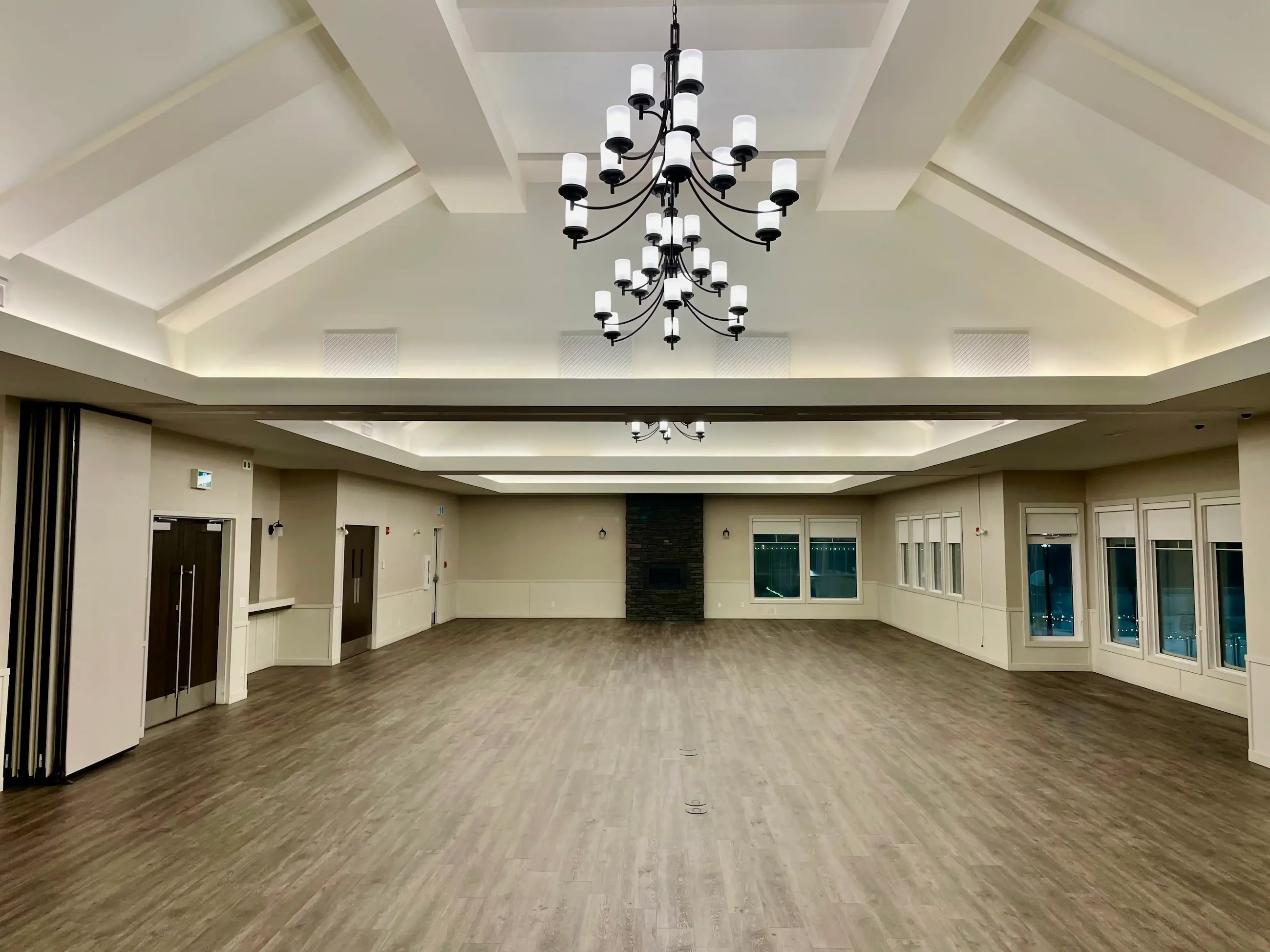 Large gathering room with finished wood-look plank flooring