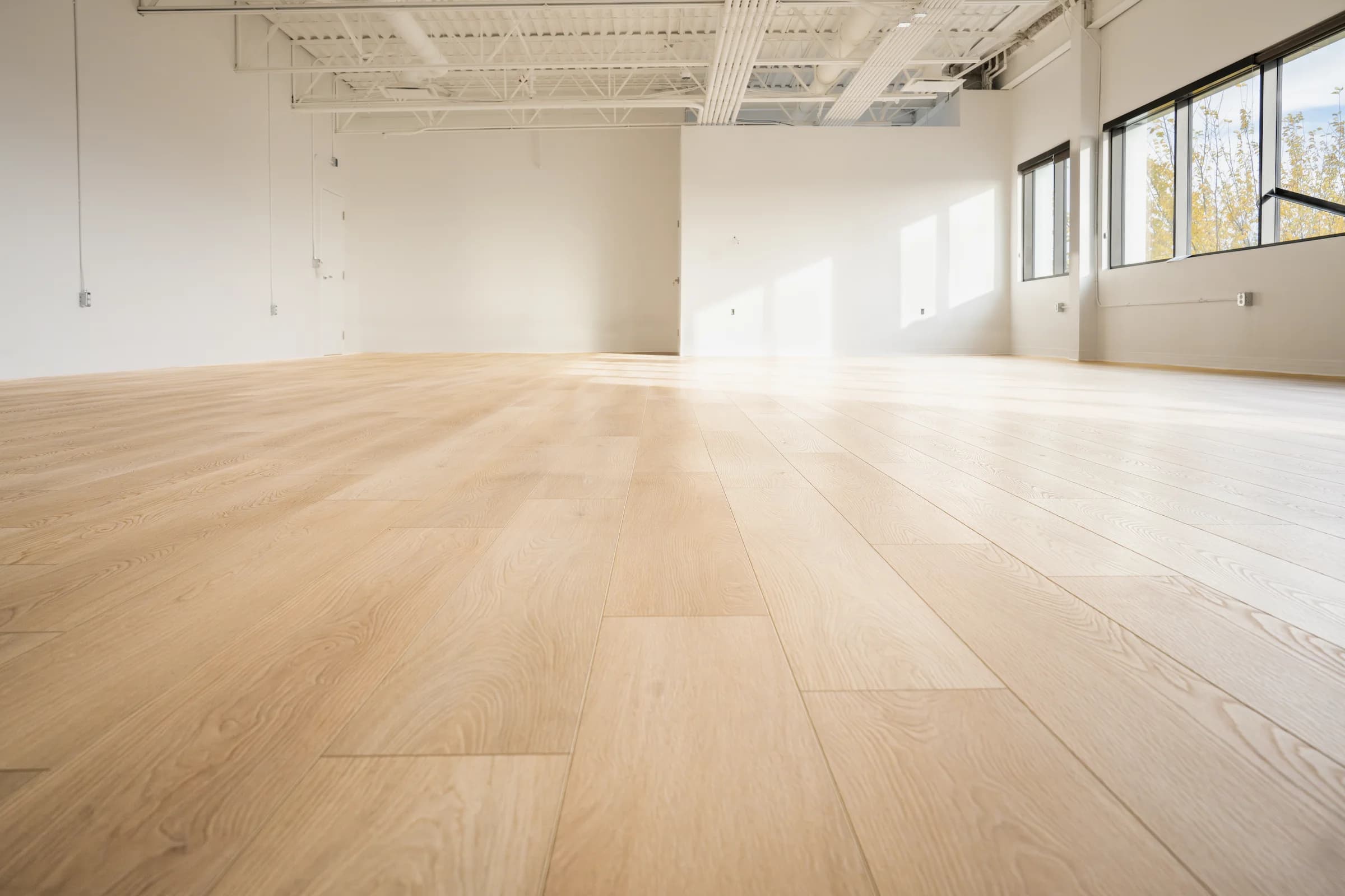 Low-angle view of wood-look plank flooring showing individual planks and seams